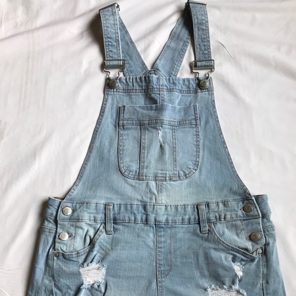 Blue spice light wash denim overall shorts.